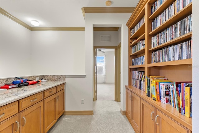 interior space with baseboards, visible vents, crown molding, and light colored carpet