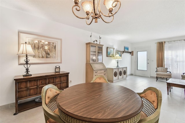 dining area featuring light tile patterned floors and a notable chandelier