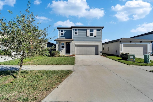 view of front of property featuring an attached garage, concrete driveway, and a front yard