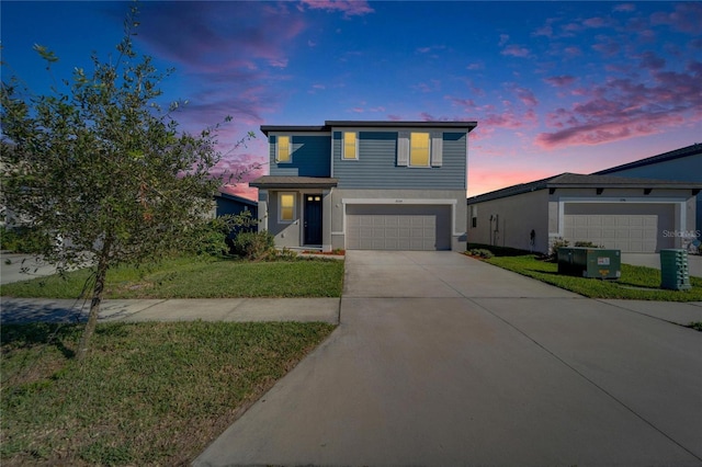 view of front facade with a garage, central air condition unit, concrete driveway, and a front yard