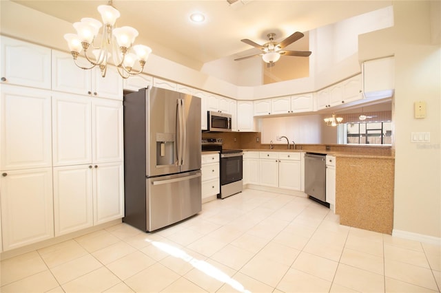 kitchen featuring light countertops, appliances with stainless steel finishes, white cabinetry, a sink, and ceiling fan with notable chandelier