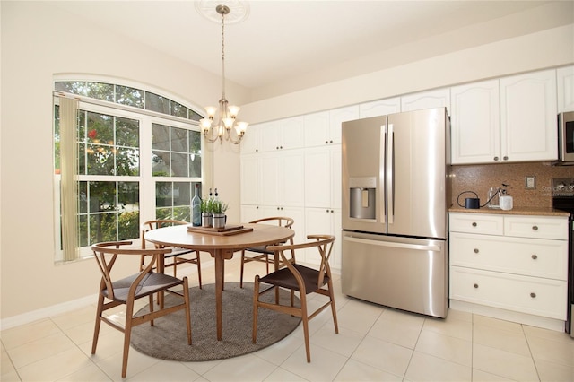 dining space with light tile patterned floors, baseboards, and an inviting chandelier