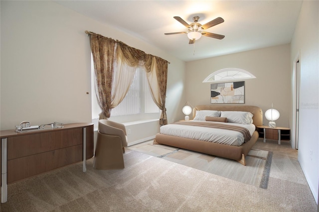 bedroom featuring light carpet and ceiling fan