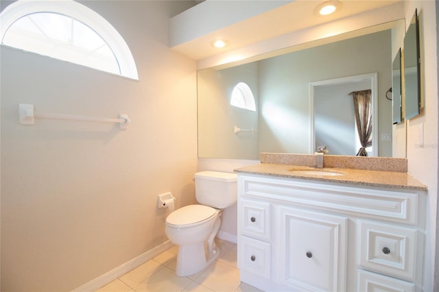 half bath featuring recessed lighting, toilet, vanity, baseboards, and tile patterned floors