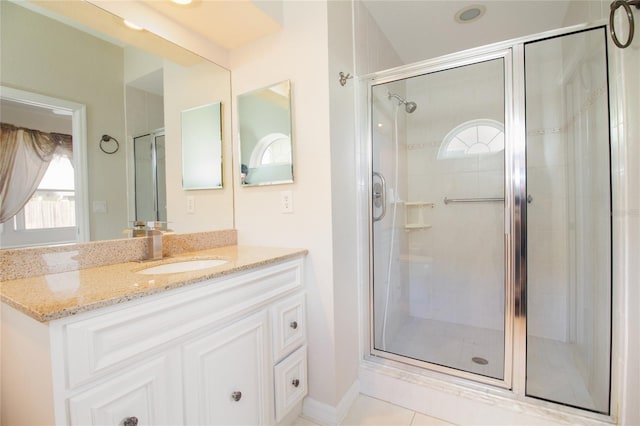 bathroom with a stall shower and vanity