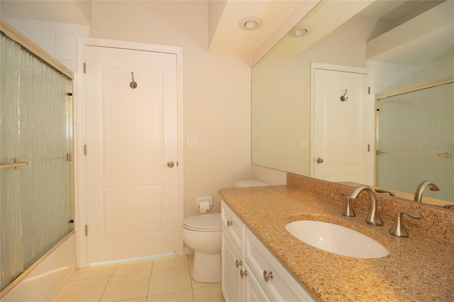 bathroom featuring tile patterned floors, vanity, toilet, and an enclosed shower