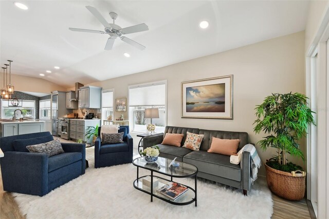 living area featuring a ceiling fan, lofted ceiling, wood finished floors, and recessed lighting