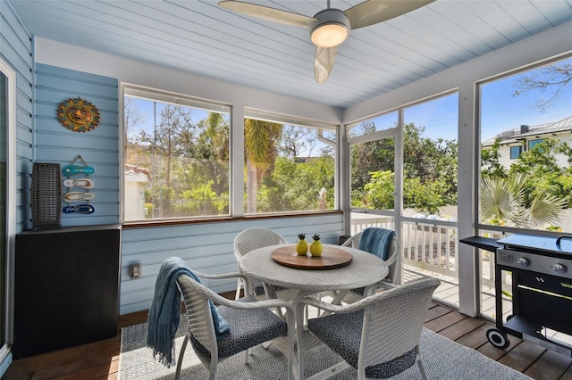 sunroom / solarium featuring wood ceiling and ceiling fan