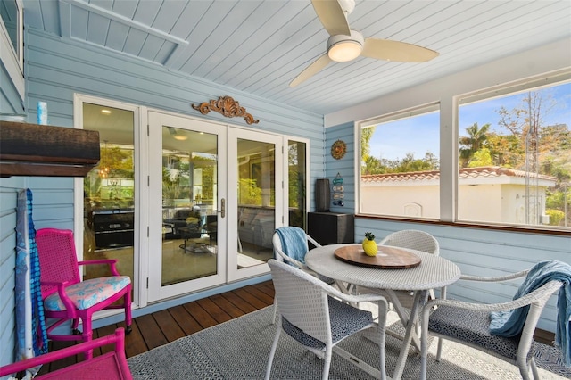 sunroom / solarium with wooden ceiling and a ceiling fan