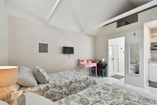 bedroom featuring vaulted ceiling, electric panel, and connected bathroom