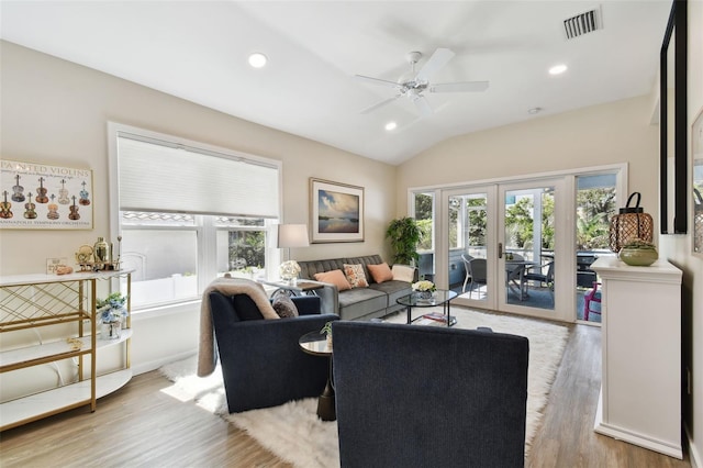 living room featuring wood finished floors, a healthy amount of sunlight, visible vents, and french doors