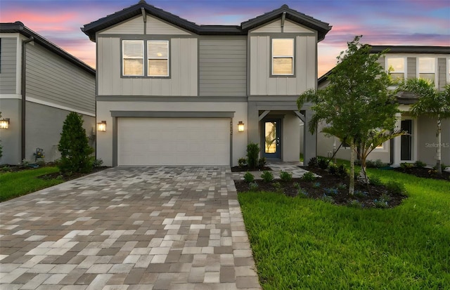 10356 Cross River Trl, Parrish, FL 34219 - view of front of property featuring driveway, a garage, a yard, and board and batten siding