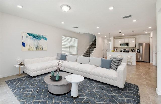 10356 Cross River Trl, Parrish, FL 34219 - living room featuring light tile patterned flooring, stairs, recessed lighting, and baseboards