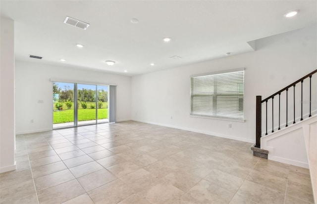 10356 Cross River Trl, Parrish, FL 34219 - spare room featuring light tile patterned flooring, recessed lighting, baseboards, and stairway