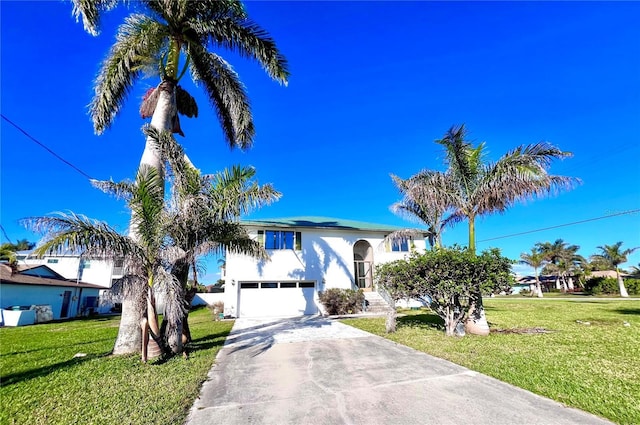 view of front of home featuring a garage, stucco siding, concrete driveway, and a front lawn