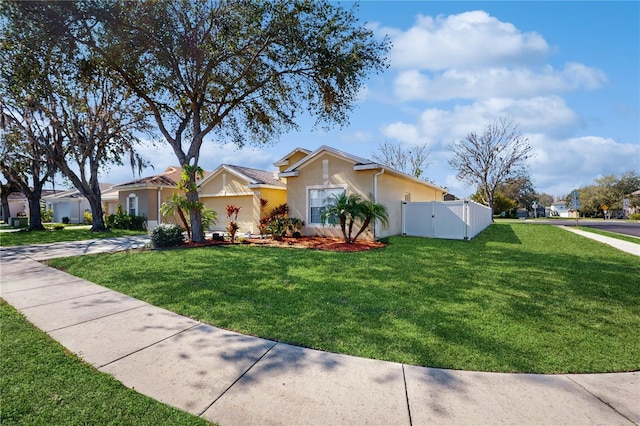 ranch-style home featuring stucco siding, a front yard, a gate, fence, and driveway