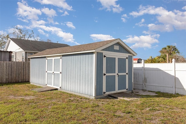 view of shed with a fenced backyard