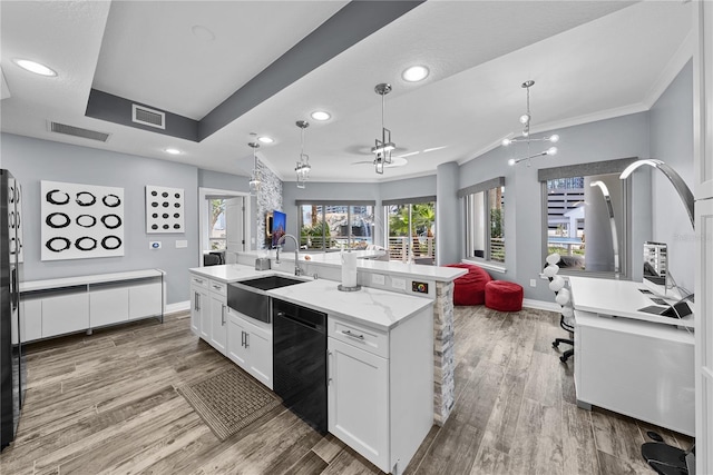 kitchen with open floor plan, black dishwasher, a sink, and visible vents