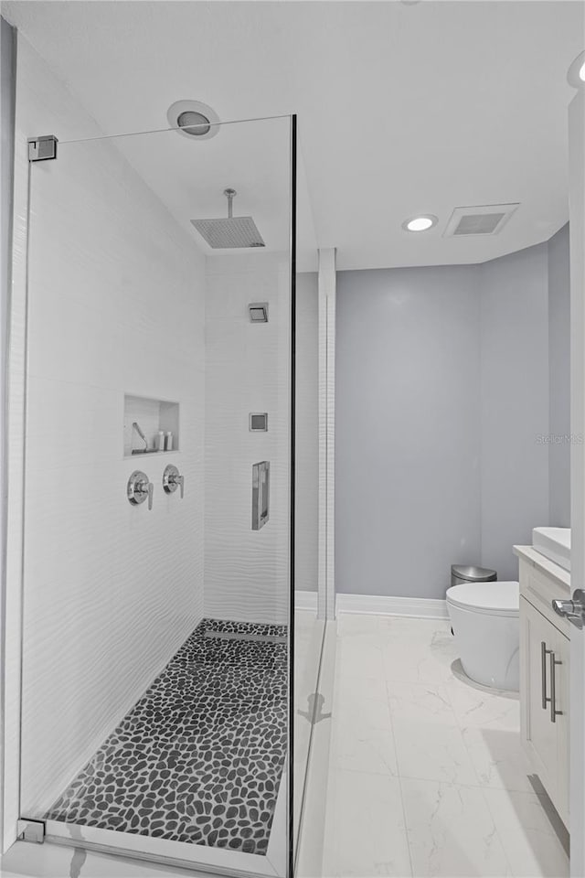 bathroom with a stall shower, marble finish floor, vanity, and toilet