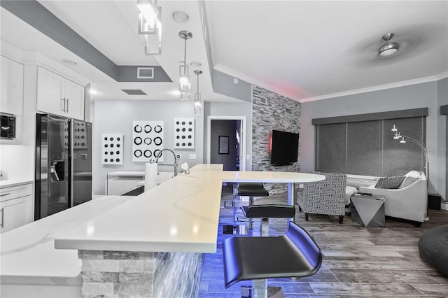 kitchen featuring ornamental molding, appliances with stainless steel finishes, visible vents, and white cabinets