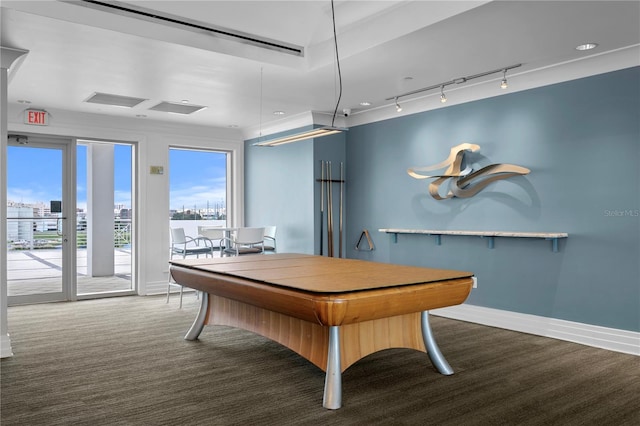 carpeted dining room featuring a view of city, baseboards, and track lighting