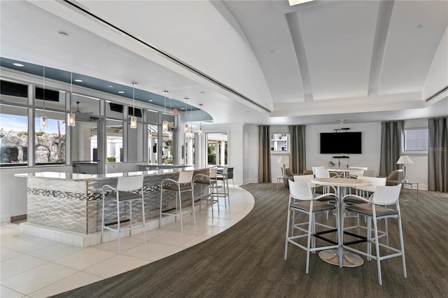 dining room with tile patterned flooring, plenty of natural light, and baseboards