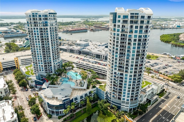 birds eye view of property with a view of city and a water view