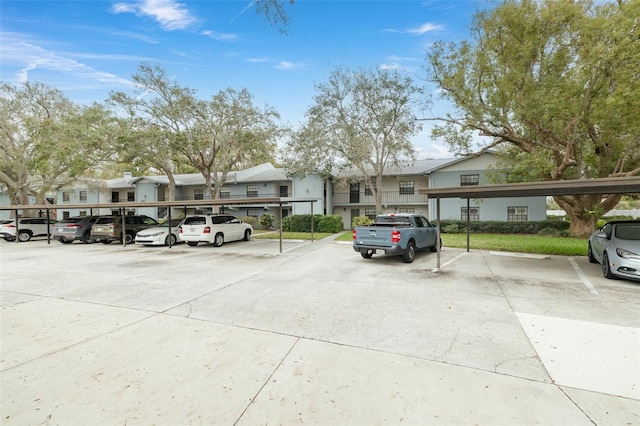 partially covered parking lot featuring a residential view