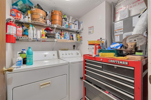 laundry room with laundry area, a textured ceiling, and washer and dryer