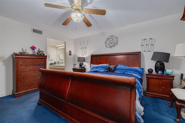 bedroom featuring dark colored carpet, visible vents, a ceiling fan, connected bathroom, and a textured ceiling