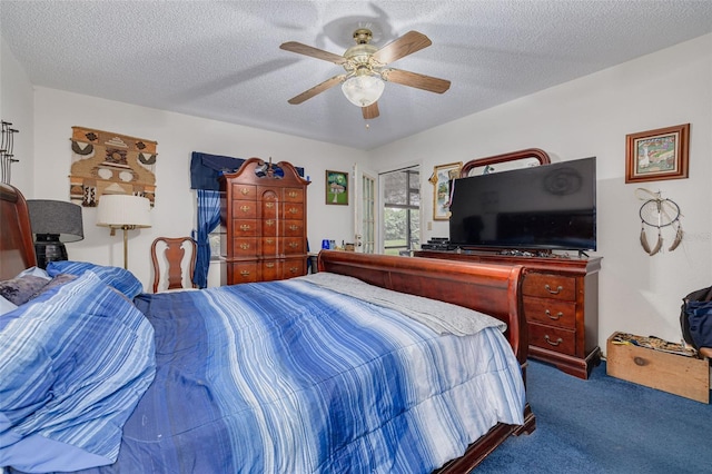 carpeted bedroom with ceiling fan and a textured ceiling