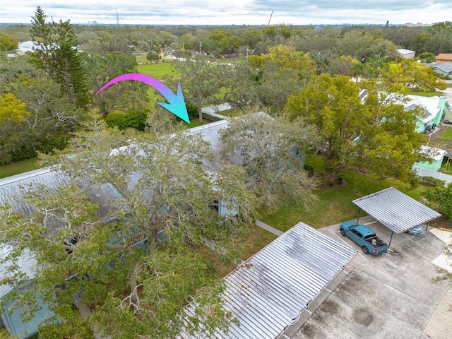 birds eye view of property with a wooded view