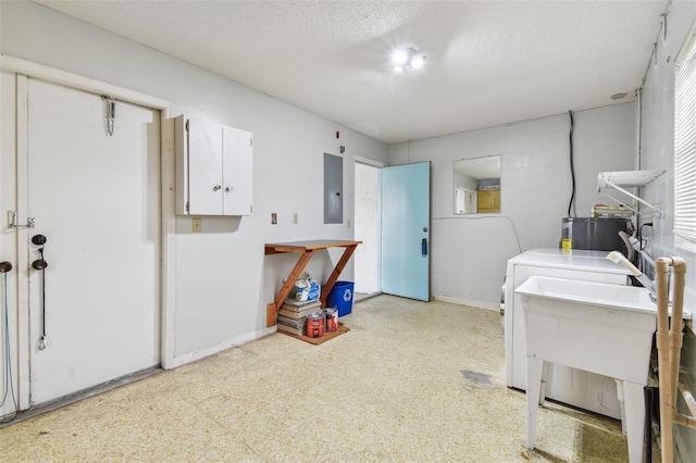 2301 Grenoble Pl Unit 1, Sun City Center, FL 33573 - washroom featuring laundry area, a textured ceiling, electric panel, water heater, and baseboards