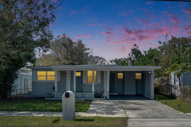 view of front facade with a yard and a carport