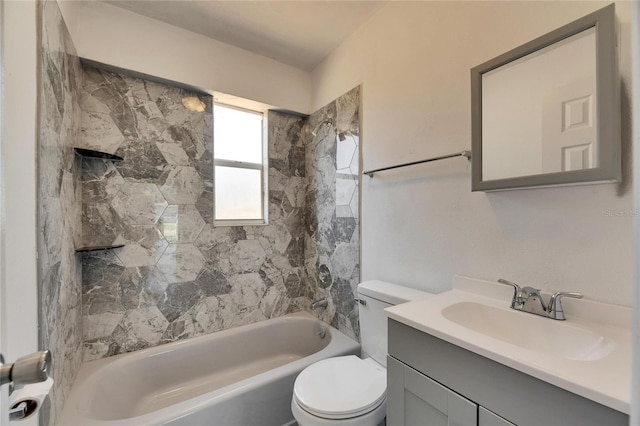 full bathroom with vanity, tiled shower / bath, and toilet