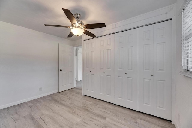 unfurnished bedroom with light hardwood / wood-style floors, a closet, and ceiling fan