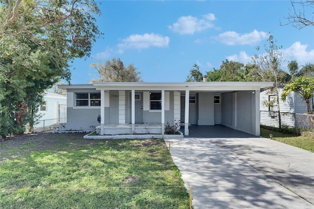 view of front of house with a carport, a porch, and a front yard