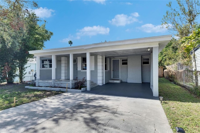 view of front of house featuring covered porch and a carport