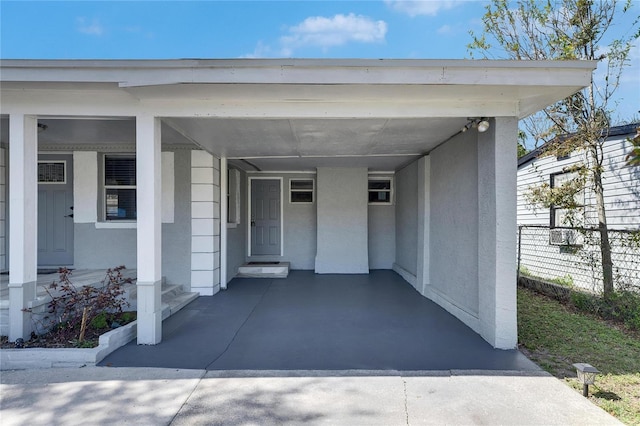 doorway to property featuring a carport