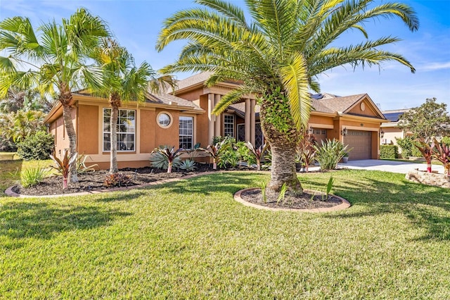 view of front of house with stucco siding, driveway, a garage, and a front lawn