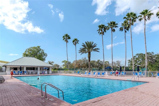 community pool featuring a patio area and fence