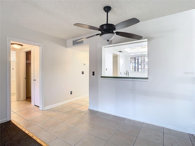 6312 Newtown Cir Unit 12A5, Tampa, FL 33615 - unfurnished room featuring visible vents, ceiling fan, a textured ceiling, and light tile patterned floors