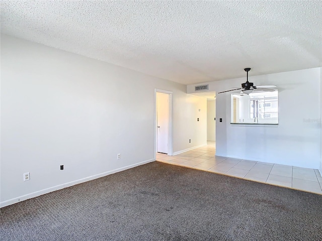 6312 Newtown Cir Unit 12A5, Tampa, FL 33615 - empty room featuring light carpet, visible vents, ceiling fan, a textured ceiling, and light tile patterned flooring