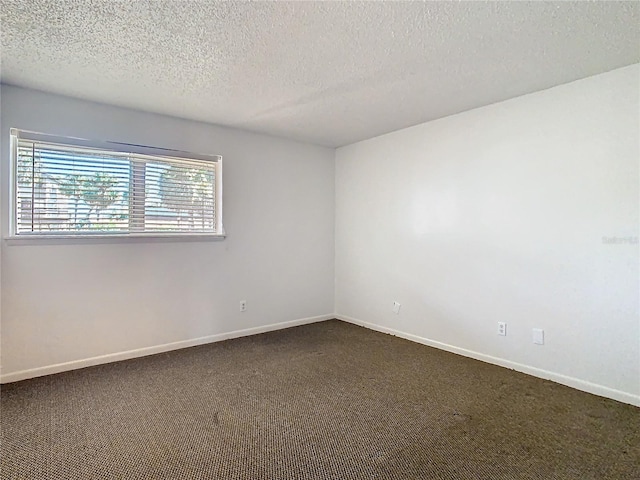 6312 Newtown Cir Unit 12A5, Tampa, FL 33615 - unfurnished room featuring a textured ceiling, dark colored carpet, and baseboards