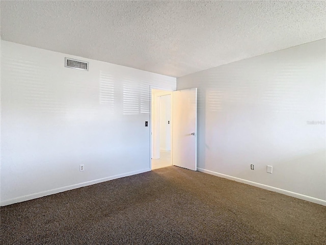 6312 Newtown Cir Unit 12A5, Tampa, FL 33615 - unfurnished room featuring a textured ceiling, dark carpet, visible vents, and baseboards