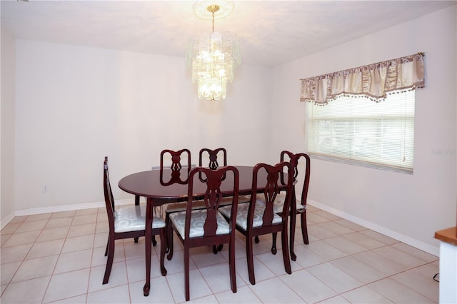 dining area featuring light tile patterned flooring, a notable chandelier, and baseboards