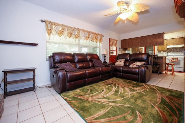 living area featuring light tile patterned floors and a ceiling fan