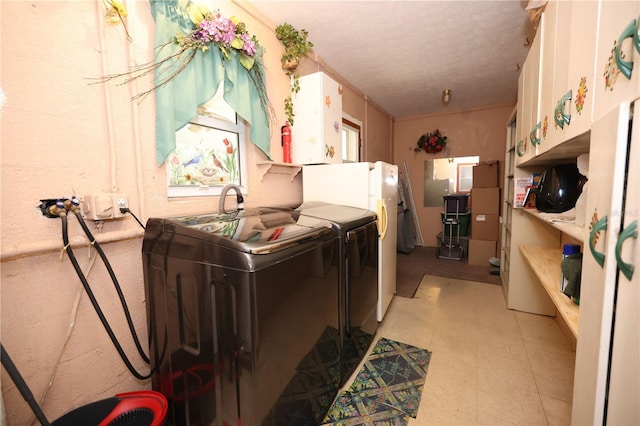 washroom with light floors, a textured ceiling, and independent washer and dryer