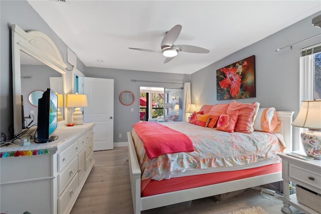 bedroom featuring ceiling fan, baseboards, and light wood-style floors