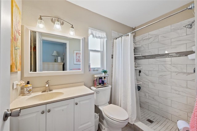 full bath featuring toilet, a stall shower, and vanity